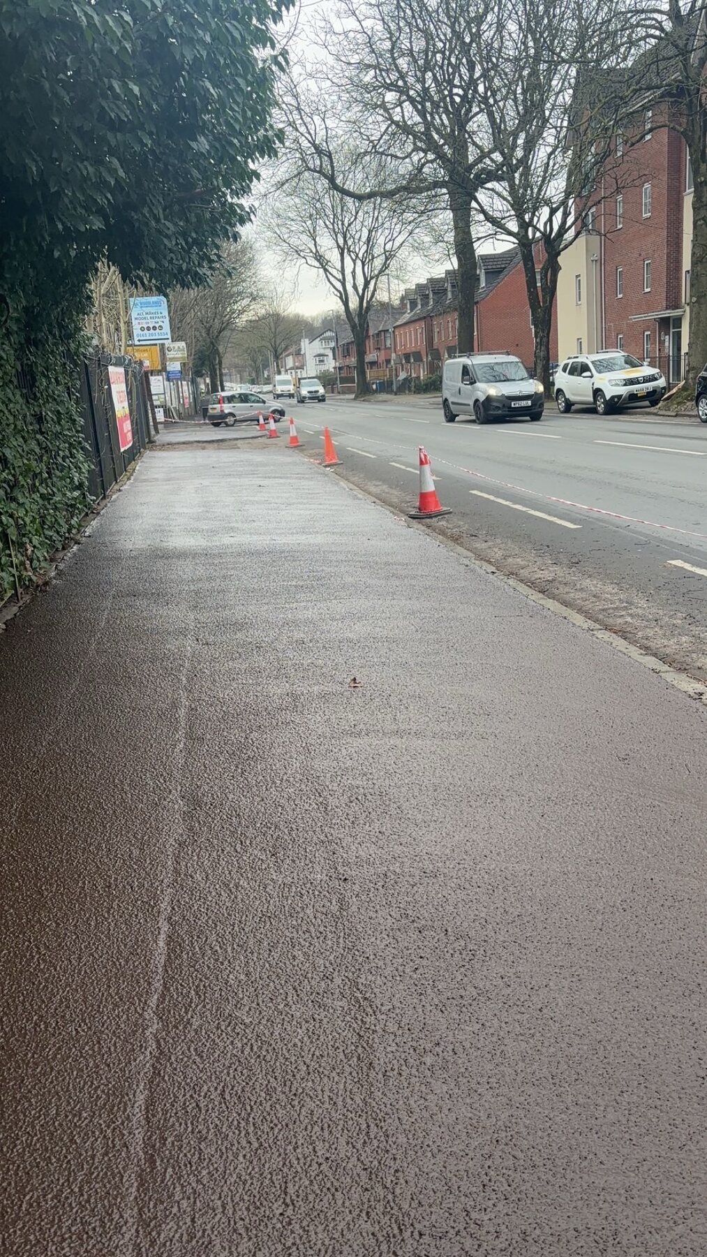Newly treated urban footway beside a main road